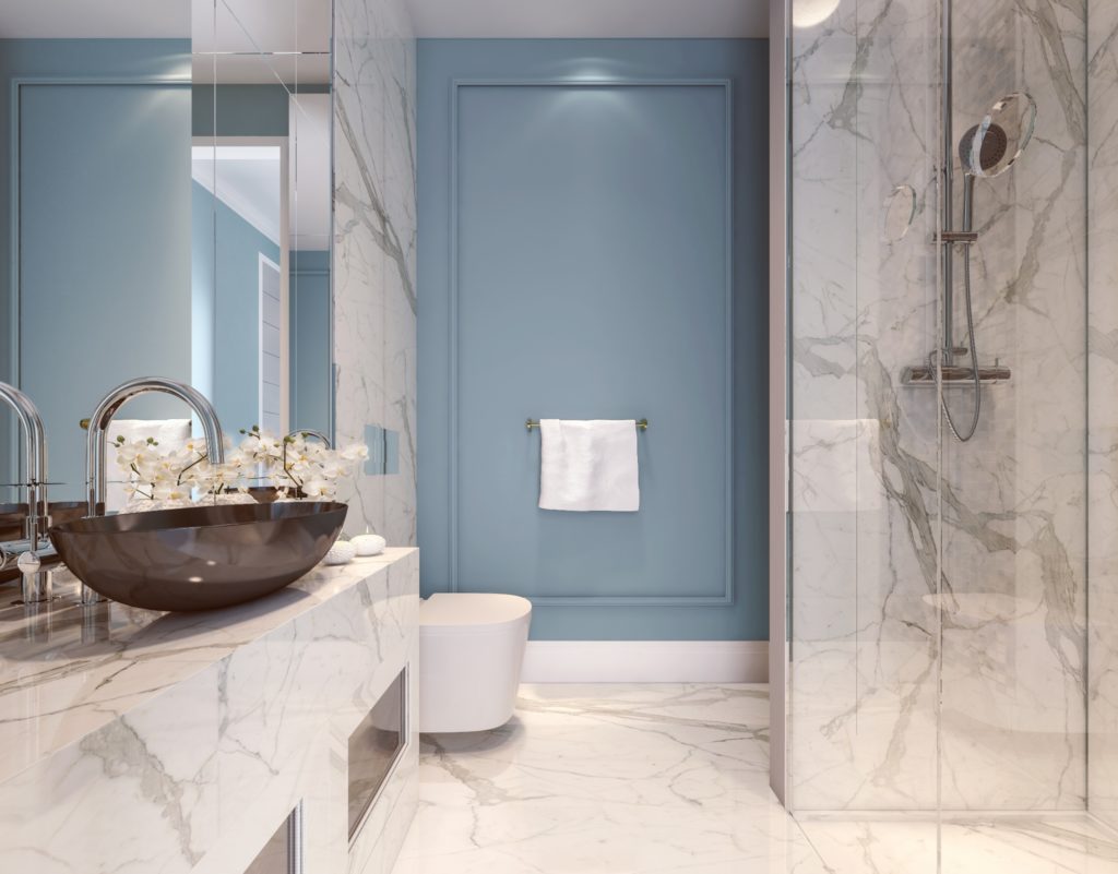 A marble bathroom with a blue wall.